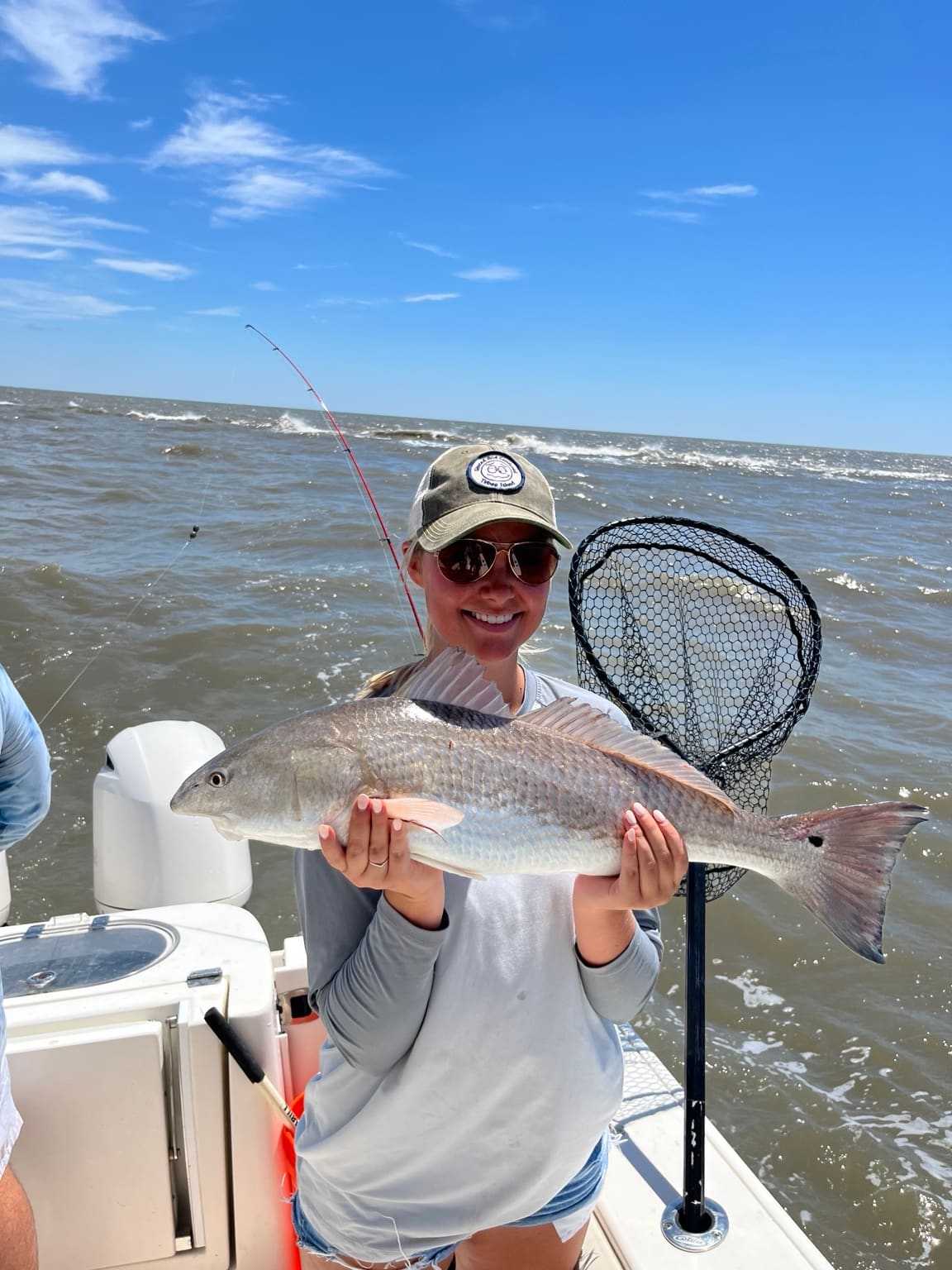 An angler with a redfish landed on a nearshore Hilton Head fishing charter