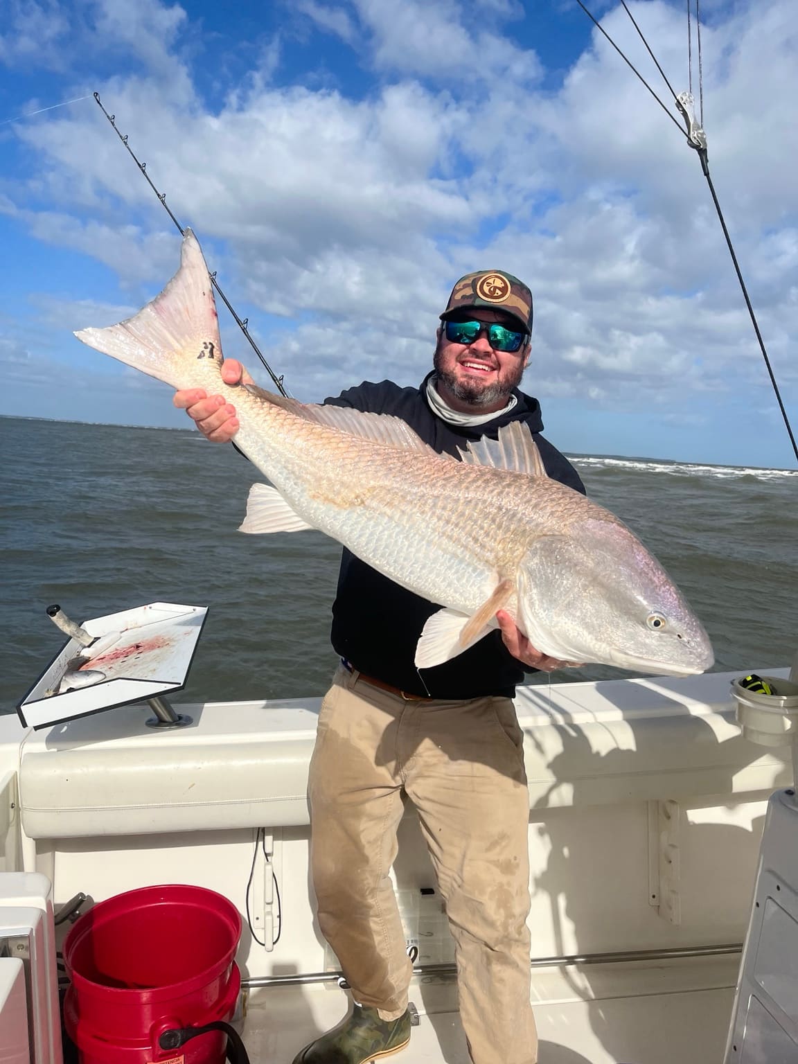 An angler holding a bull redfish caught in Lowcountry waters off Hilton Head