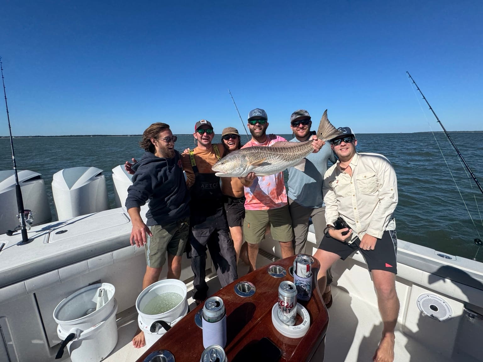 A group of six friends with a bull redfish on a private Southern Hook charter