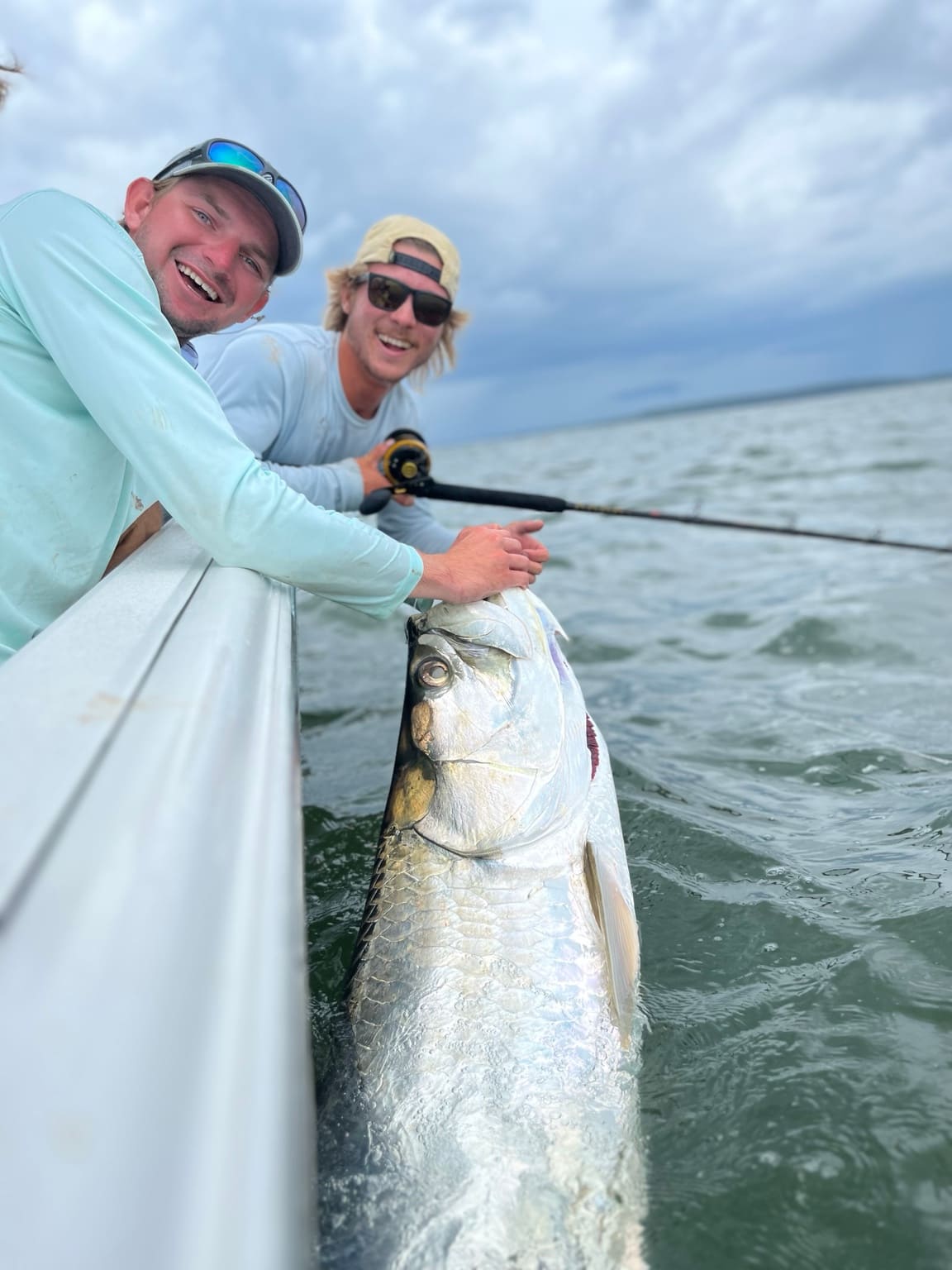 Anglers with a tarpon boatside before release in Lowcountry waters