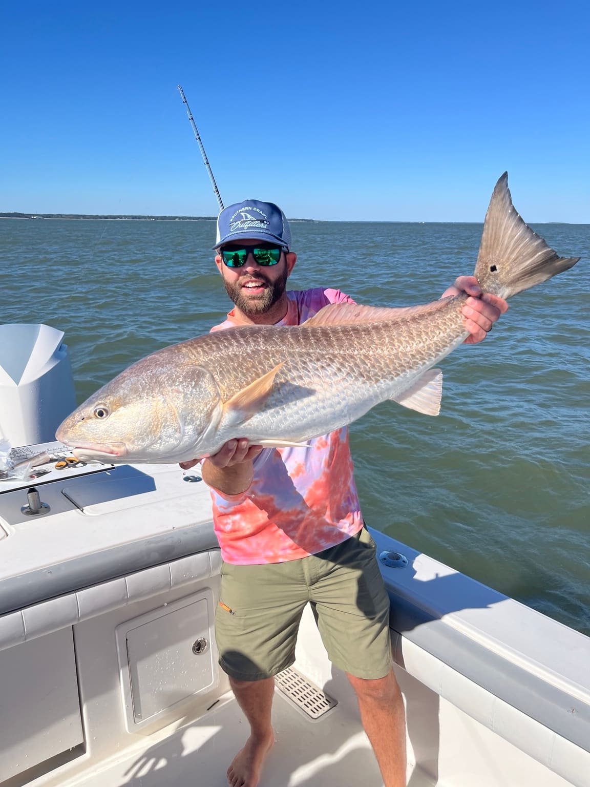 A trophy bull redfish held up before release off Hilton Head